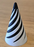 Black-and-white cone-shaped Spiral Fidget on a wooden surface