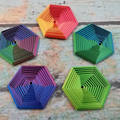 Five colorful hexagonal fidgets with nested layers and gradient colors