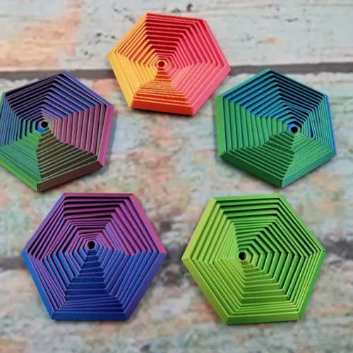 Five colorful hexagonal fidgets with nested layers and gradient colors